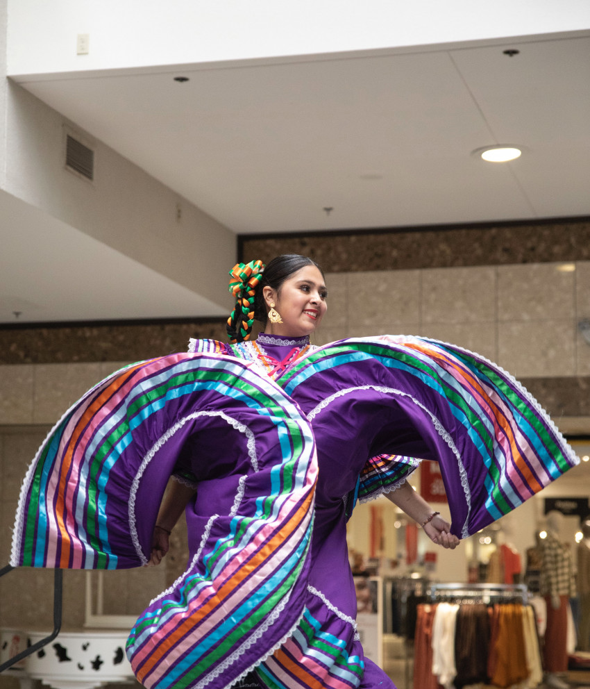 Traditional purple folklórico dance dress in motion