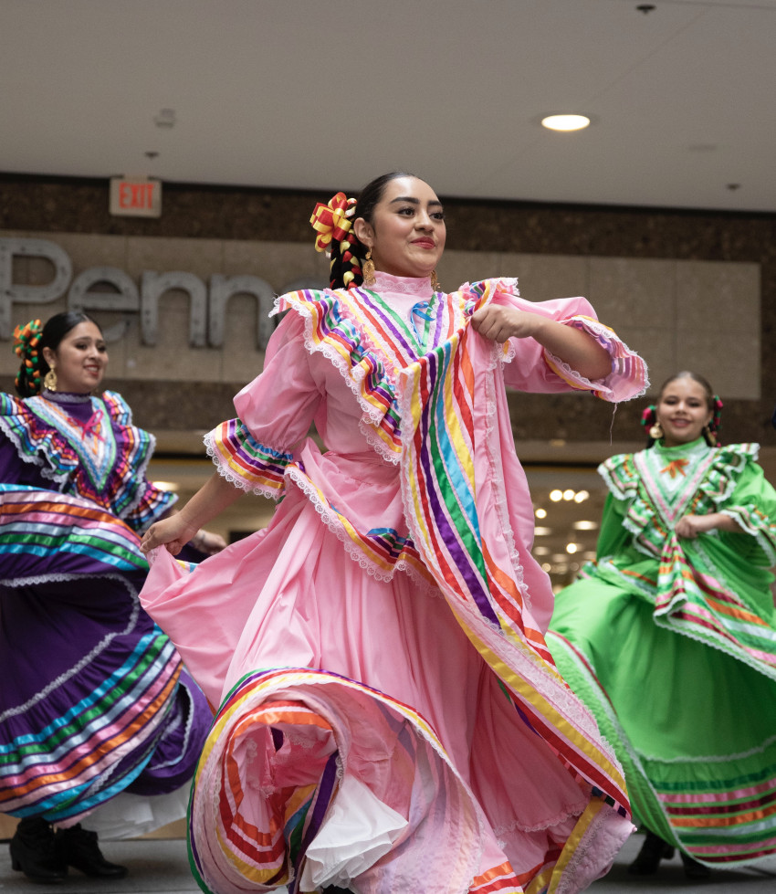 Members of Grupo Folklórico de Bendiciones dancing in traditional colorful costumes